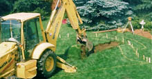 Backhoe Yellow Backhoe Breaking Ground For Backyard Swimming Pool